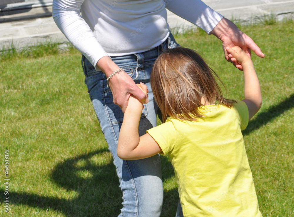 Obraz premium unrecognisable mother and daughter playing outdoor