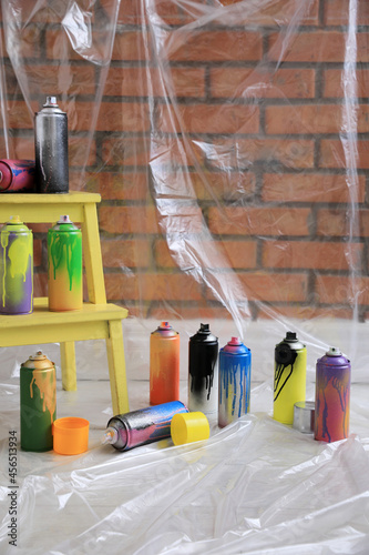 Used cans of spray paints indoors. Graffiti supplies