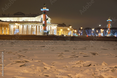 Frozen river, beautiful rastral columns with Christmas decorations
