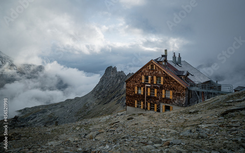 Alpine hut Defreggerhaus is a refuge of the Austrian Tourist Club on Grossvenediger in East Tyrol. Glacier and mountain panorama in the Hohe Tauern Alps, Austria photo