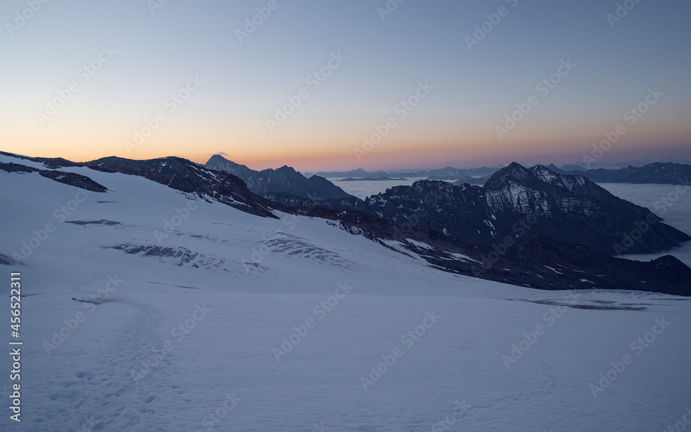 Amazing morning, fog in the valley and illuminated glacial mountains. Trek to Grossvenediger glacier in Hohe Tauern national park, Austria Amazing morning, fog in the valley and illuminated glacial mountains. Trek to Grossvenediger glacier in Hohe Tauern national park, Austria