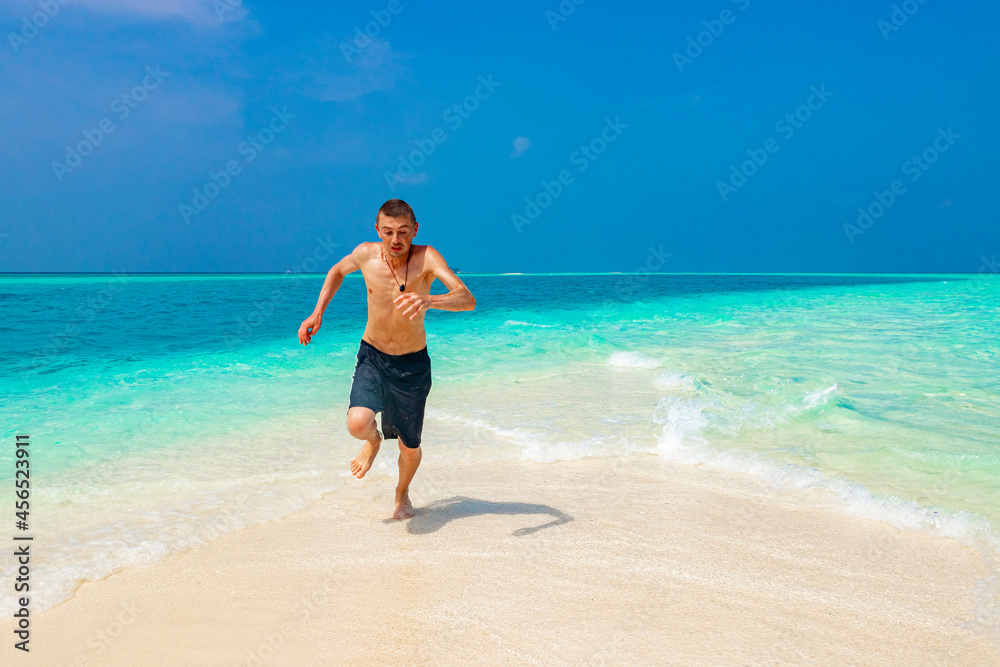 Funny tourist enjoys vacation on island Madivaru Finolhu Rasdhoo Maldives.