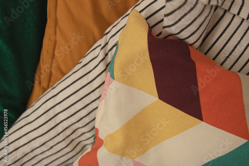 colorful pillows patterns stack on each other, cozy background