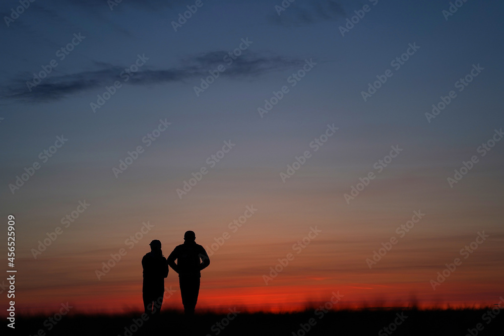 a couple of people after sunset