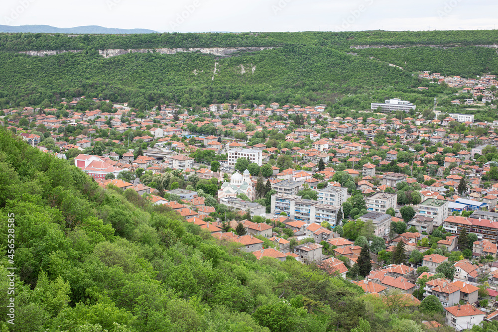 Small bulgarian city at the foot of the mountain. Small houses, administrative buildings, parks.