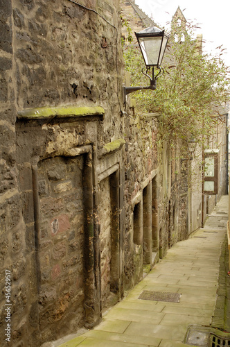 historic close with lamp off Canongate in Edinburgh photo