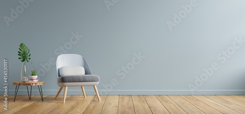 Armchair and wooden table in living room interior,blue wall.