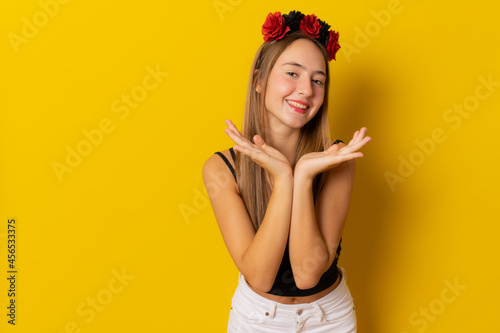 Young smiling woman in halloween costume isolated on yellow background