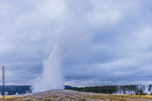 Old Faithful geyser eruption at Yellowstone National Park, USA