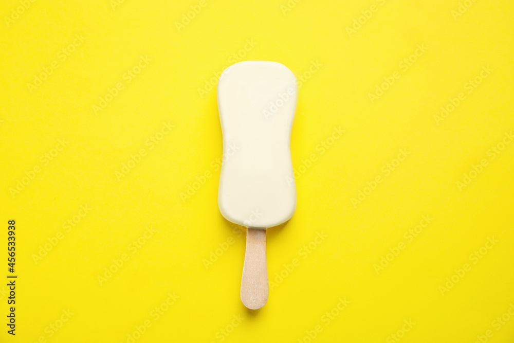 Ice cream with glaze on yellow background, top view