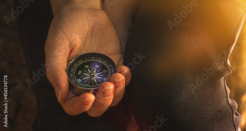 Traveler using compass in the woods