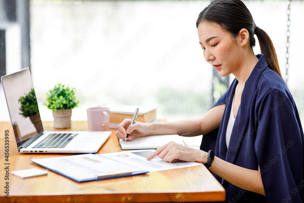 Shot of a asian young business Female working on laptop computer in her workstation.Portrait of Business people employee freelance online marketing e-commerce telemarketing concept. Shot of a asian young business Female working on laptop computer in her workstation.Portrait of Business people employee freelance online marketing e-commerce telemarketing concept.