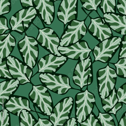 Seamless pattern Spinach salad on teal background. Abstract ornament with lettuce.