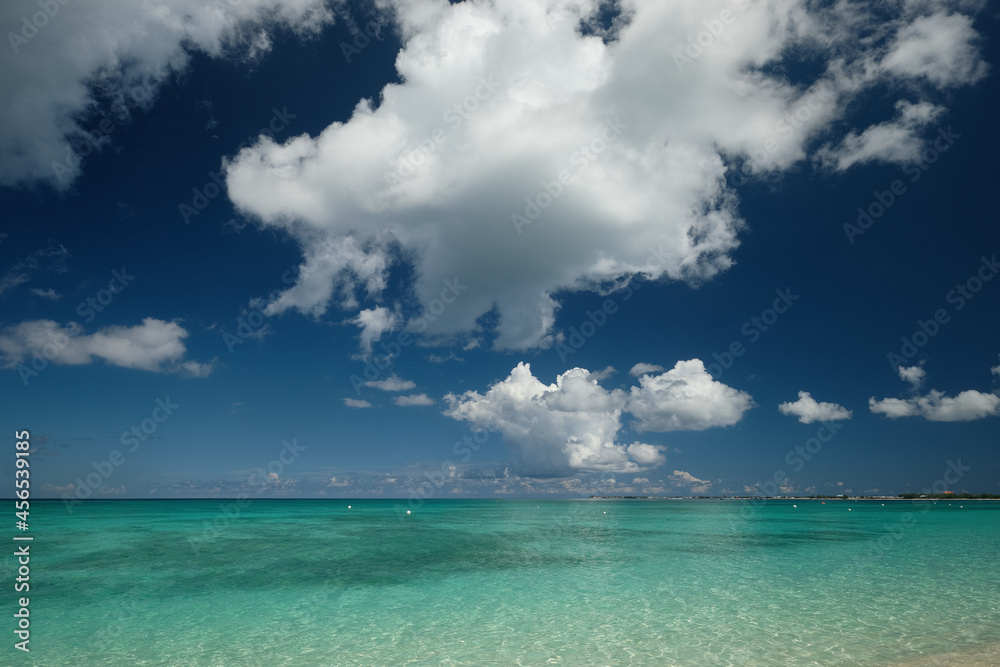 Crystal clear waters and pinkish sands on empty seven mile beach on tropical carribean Grand Cayman Island Crystal clear waters and pinkish sands on empty seven mile beach on tropical carribean Grand Cayman Island