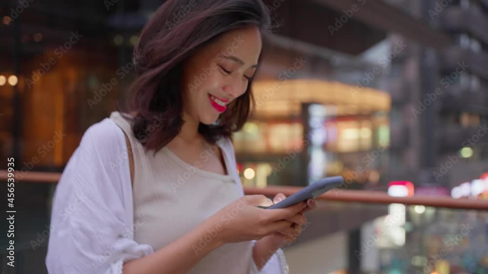 pretty young asian woman using mobile phone in the city street at urban Chengdu in summer evening 4k slow motion footage pretty young asian woman using mobile phone in the city street at urban Chengdu in summer evening 4k slow motion footage