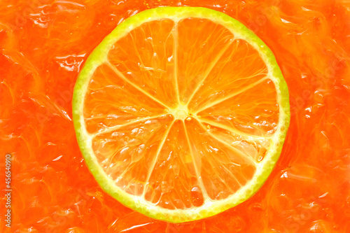 Orange sliced on cool orange juice with ice.