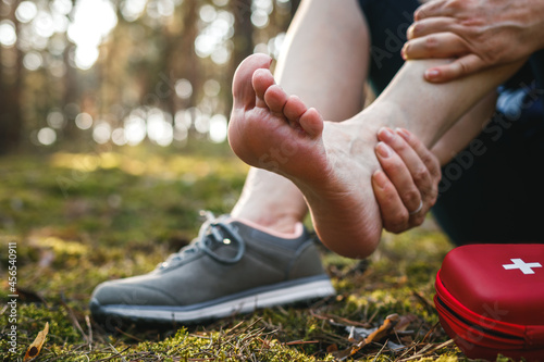 Bild auf Leinwand Sprain ankle during hiking in nature