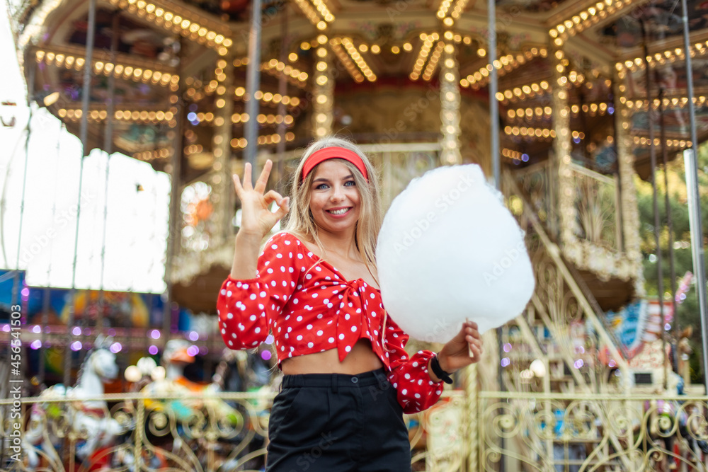 custom made wallpaper toronto digitalAdorable cute beautiful woman with cotton candy stands in the middle of an amusement park with bright colors, positive and cheerful, happy and optimistic emotion