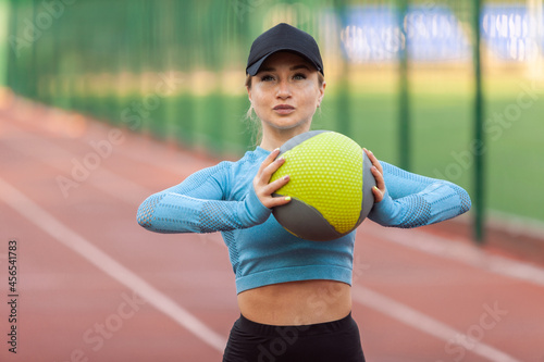 Young athletic woman in sportswear with medicine ball  at the stadium © splitov27