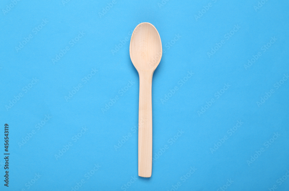 Wooden culinary spoon on blue background Wooden culinary spoon on blue background