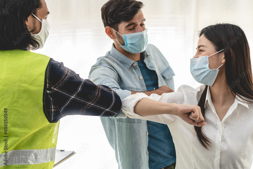 Teamwork of builder worker team. Group of people using elbow touching to show teamwork Teamwork of builder worker team. Group of people using elbow touching to show teamwork