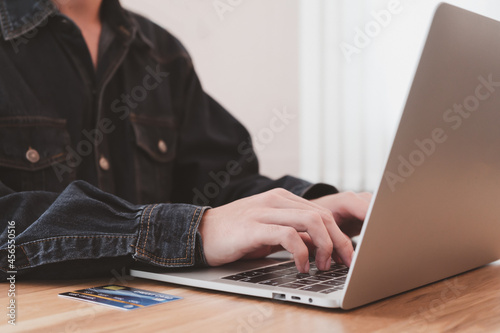 Online shopping using online payment. business typing keyboard laptop with mock up credit card on wood desk in office. Quick and easy spending, Technology e-commerce, Online Market concept