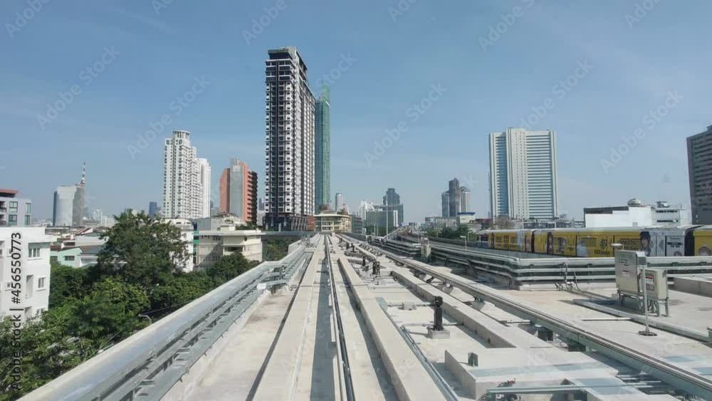 The train moves forward along the track. Building view on the roadside, Bangkok, Thailand