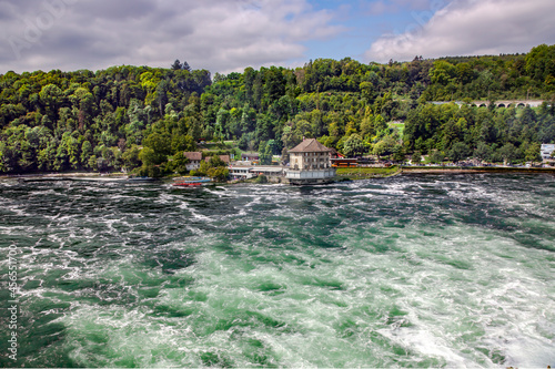 Mighty white rapids of the Rhine River at the Rhine Falls, the famous and biggest waterfall in Europe located in Schaffhausen, Switzerland 