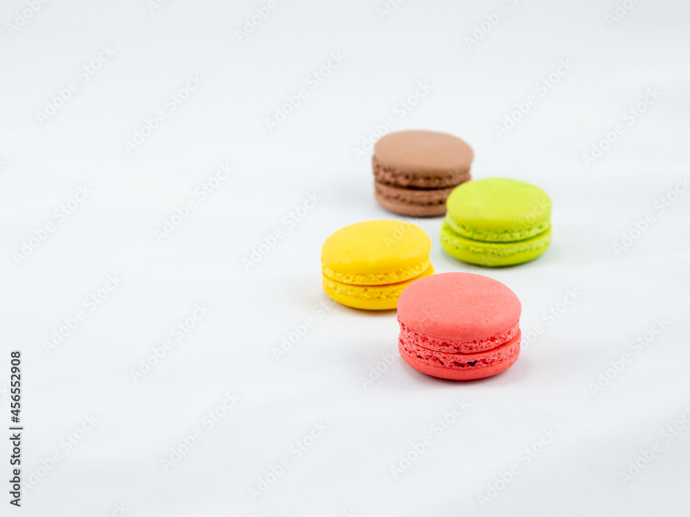 Sweet and Colorful four macaroons lying togehter on white background Sweet and Colorful four macaroons lying togehter on white background