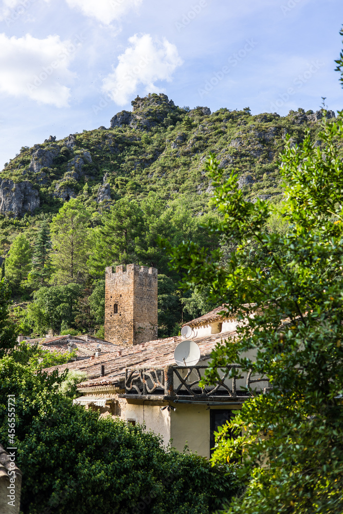 Vue sur le village médiéval de Saint-Guilhem-le-Désert dominé par un château en ruine (Occitanie, France)