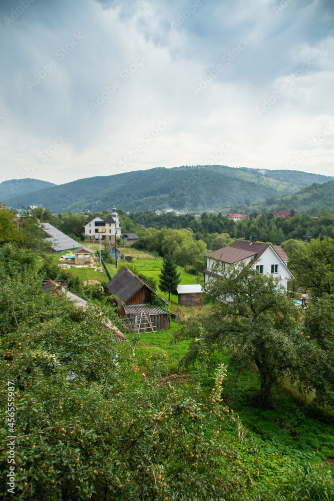 View over rural houses and Carpathian mountains in Yaremche, Ukraine.