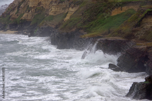  Section of the rough and wild Central California coast on a cloudy and foggy early summer day