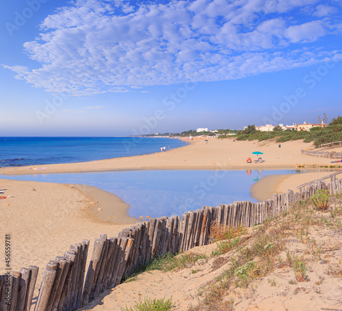 Typical sandy beach with dunes in Puglia, Italy: the beach of Chidro near the town of San Pietro in Bevagna, where the Chidro river mouth flows which creates three freshwater lakes and then reaches th photo