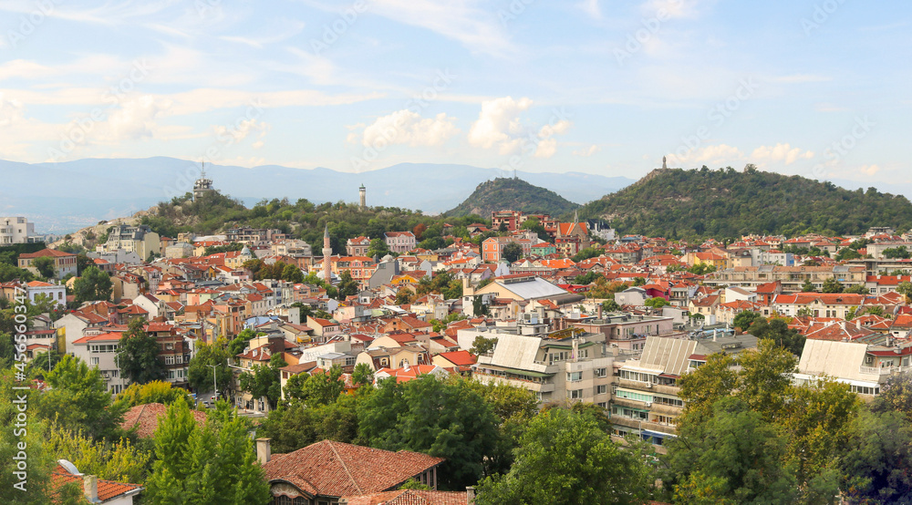 panoramic landscape of Plovdiv from the old town with views of the entire city from above - tourist postcard for a wallpaper with the buildings and monuments, the hills, mountains and a blue sky
