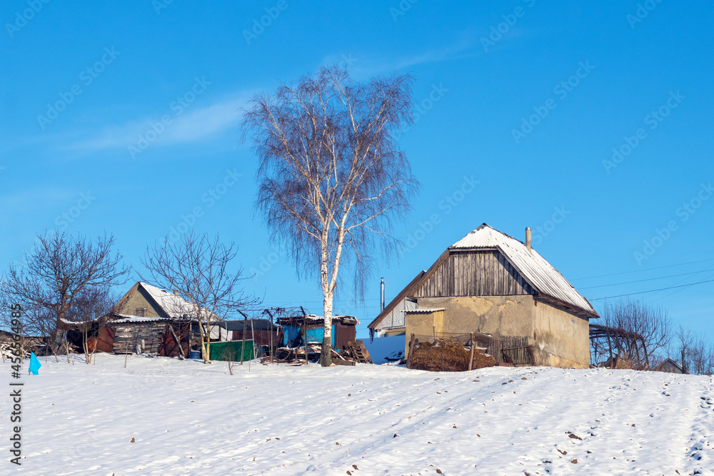 Old village houses in winter on a sunny day