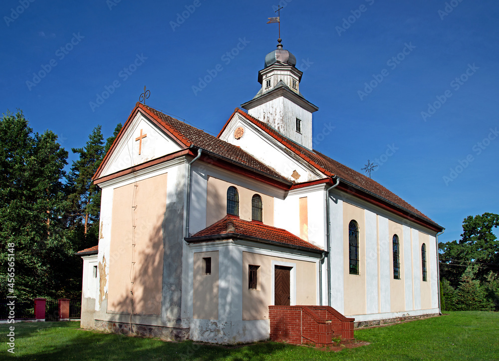 General view and architectural details of the Catholic church built in 1873 with the belfry under the patronage of Saint Joseph in Opaleniec in warmia, Poland.