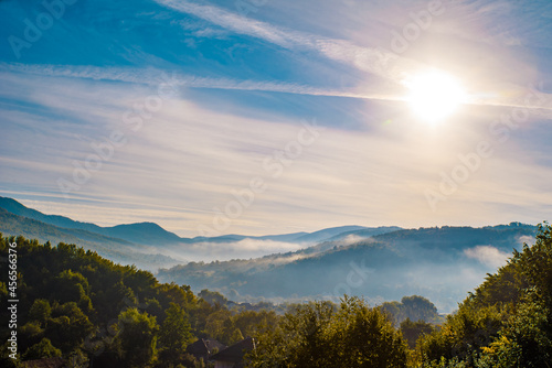 morning fog at sunrise over a mountain village in the mountains. Countryside. © robertuzhbt89