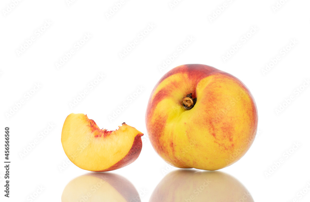 One slice of sweet nectarine and one whole nectarine, close-up, isolated on white.