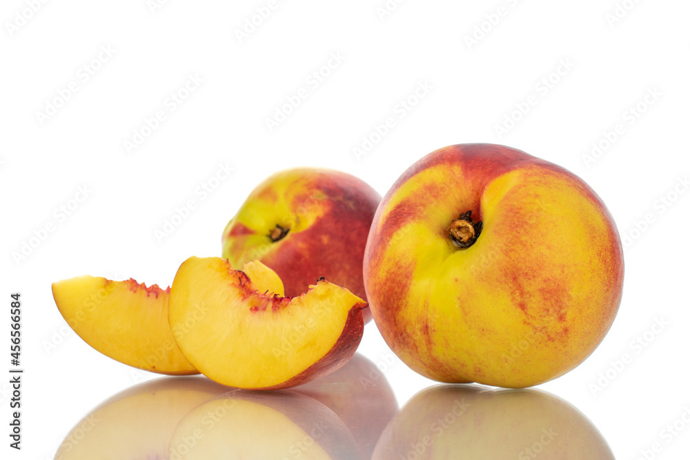 Two slices of sweet nectarine and two whole, close-up, isolated on white. Two slices of sweet nectarine and two whole, close-up, isolated on white.