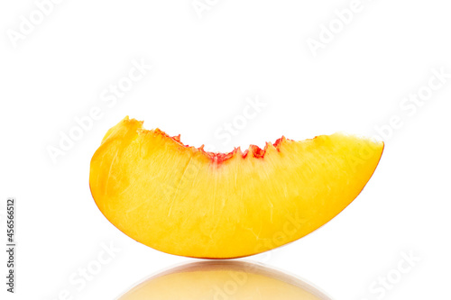 One slice of sweet nectarine, close-up, isolated on white.