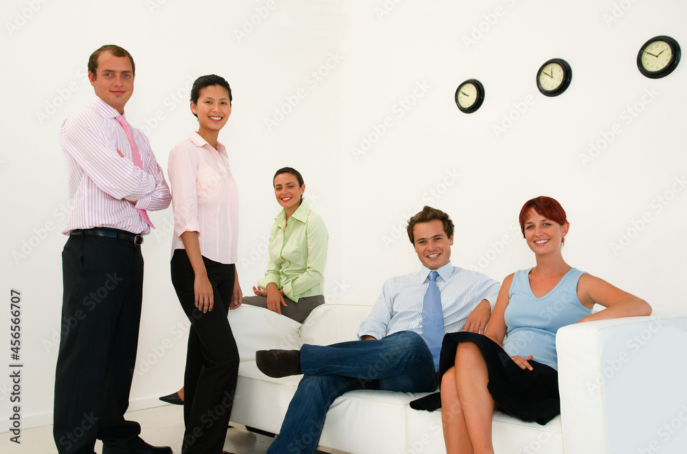 Business people smiling in lobby area Business people smiling in lobby area