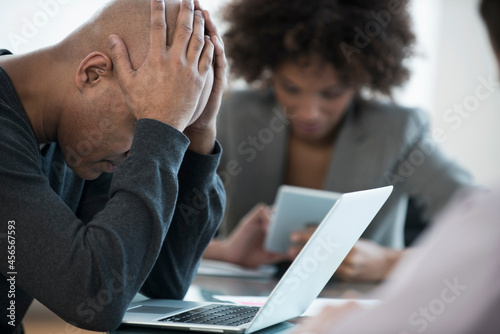 Schilderij op canvas Frustrated businessman using laptop