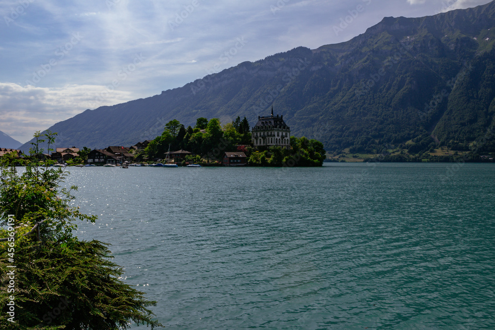View of village and former castle on Lake Brienz in swiss village Iseltwald