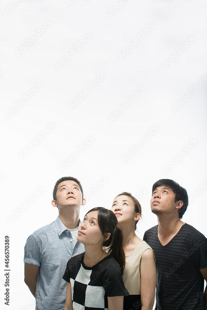 Fototapeta premium Young adults looking up