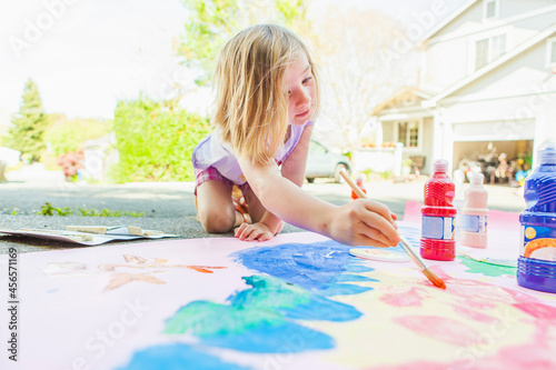 Photography Girl painting with tempera on paper