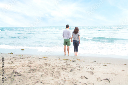 Young couple holding hands beach