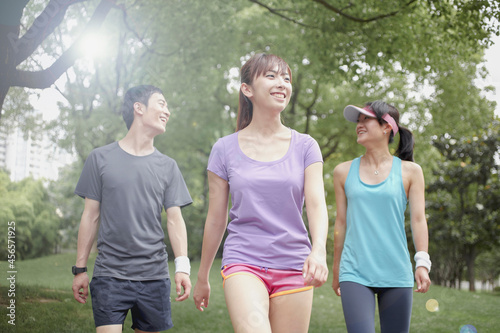 Three young joggers in park