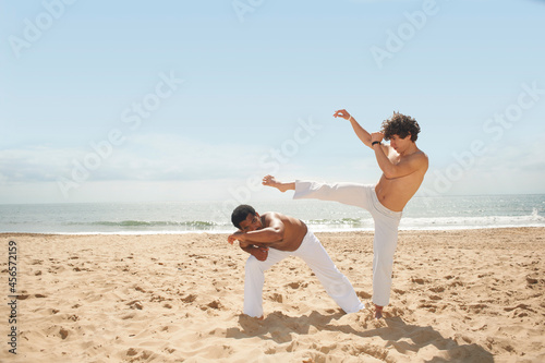 Photos Men doing capoeira on beach