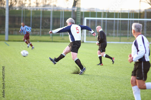 Photos Football player kicking ball
