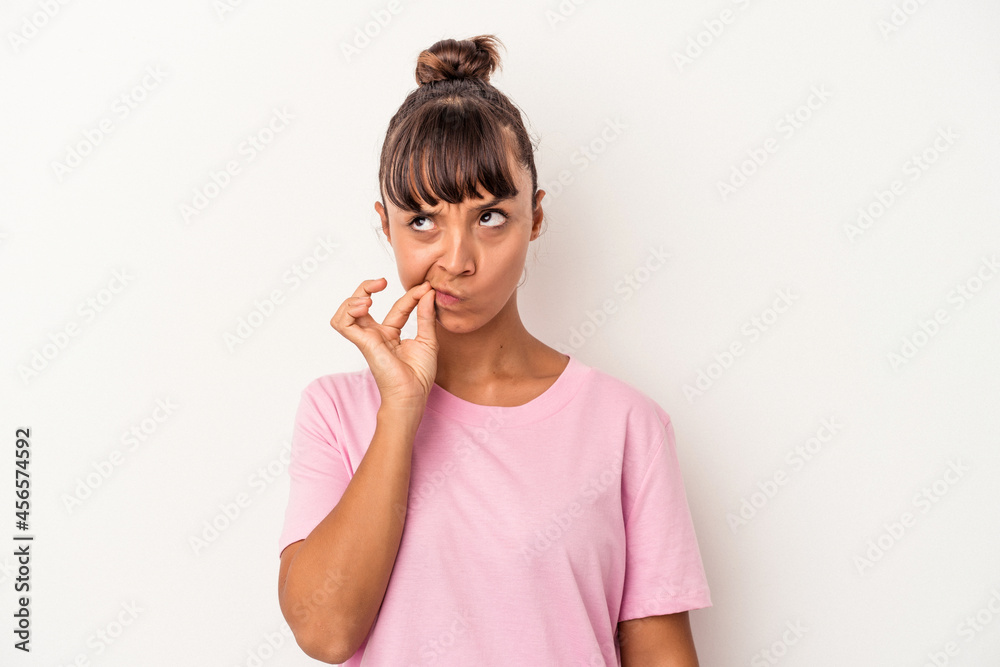 Young mixed race woman isolated on white background with fingers on lips keeping a secret. Young mixed race woman isolated on white background with fingers on lips keeping a secret.